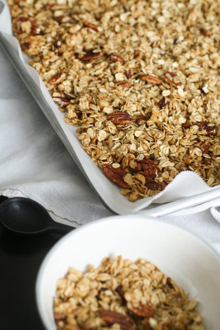 Freshly baked homemade granola with pecans in a kitchen setting, perfect for a healthy breakfast.